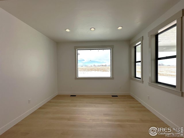 empty room with light hardwood / wood-style floors