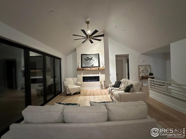 living room with ceiling fan, lofted ceiling, and hardwood / wood-style flooring