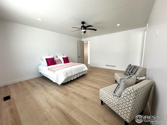 bedroom with ceiling fan and light hardwood / wood-style flooring