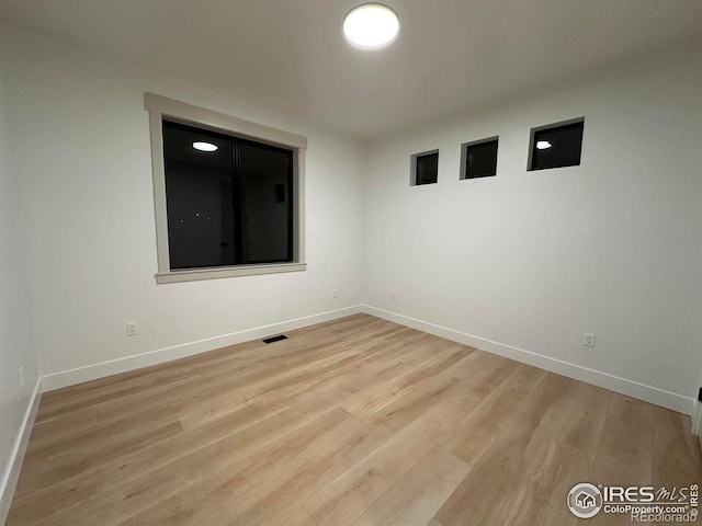 unfurnished room with light hardwood / wood-style flooring