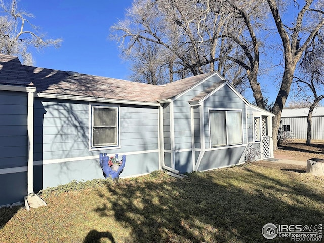 view of side of property with a yard