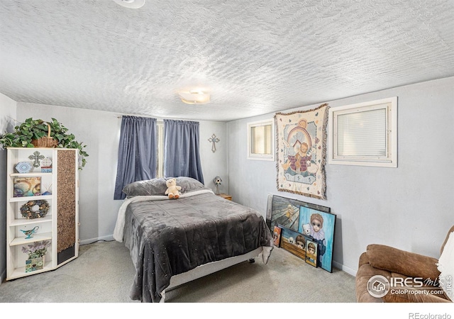 bedroom featuring carpet flooring and a textured ceiling