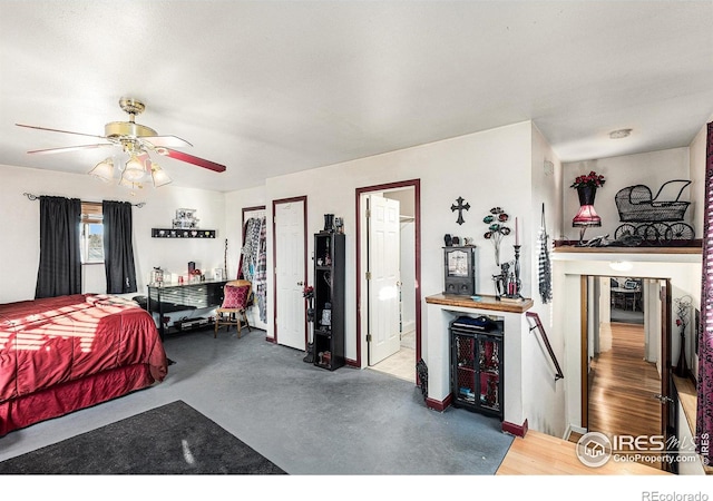 bedroom with ceiling fan and concrete floors