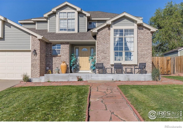 view of front of home featuring a front yard and a garage