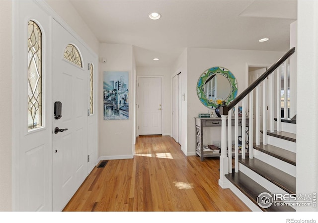 entryway with light hardwood / wood-style flooring and a healthy amount of sunlight