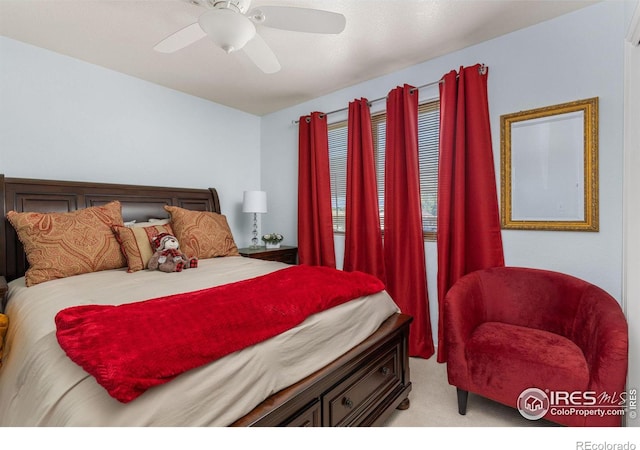 bedroom with ceiling fan and light carpet