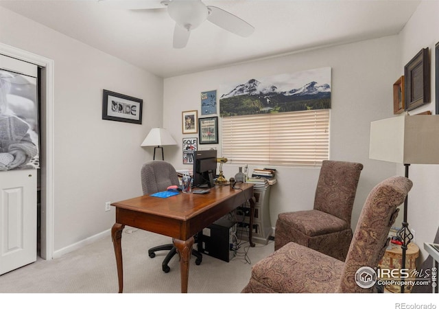 carpeted home office featuring ceiling fan