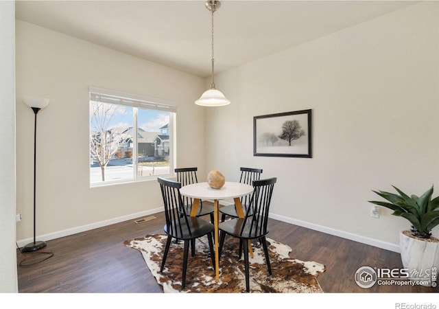 dining room with dark hardwood / wood-style flooring