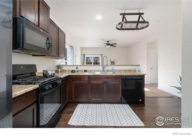 kitchen with dark wood-type flooring, ceiling fan, sink, and black appliances