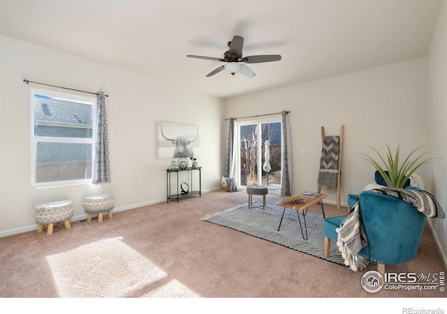 living area with carpet flooring and ceiling fan