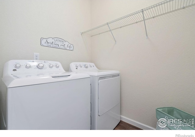 laundry room featuring dark wood-type flooring and washer and dryer