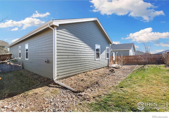 view of home's exterior with a yard