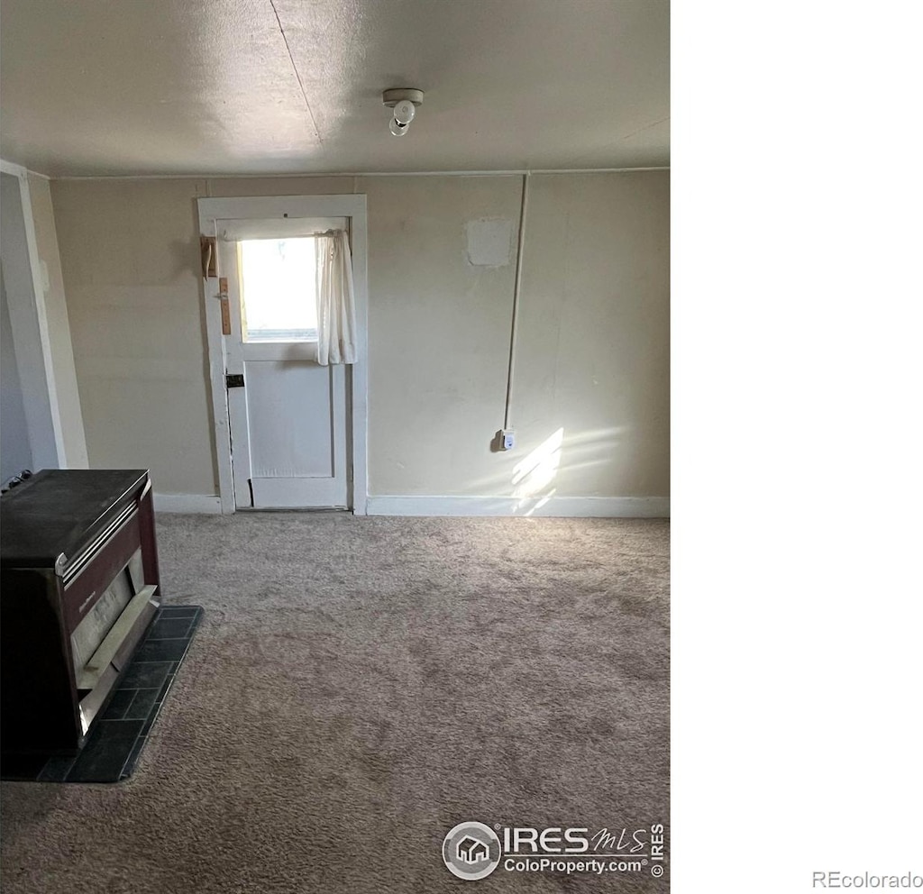 spare room with dark colored carpet and a textured ceiling