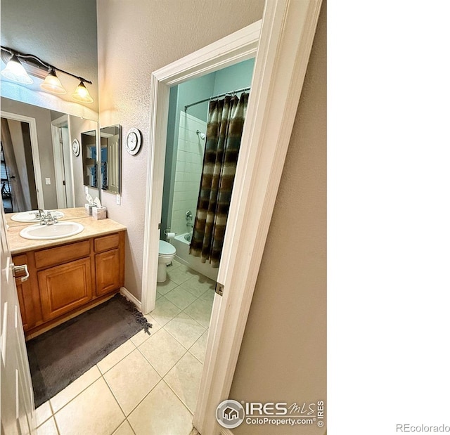 full bathroom featuring tile patterned floors, shower / bath combination with curtain, toilet, and vanity