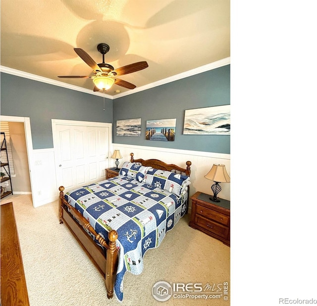 bedroom featuring carpet, a closet, ceiling fan, and crown molding