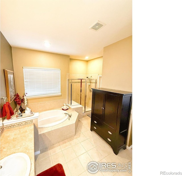 bathroom with tile patterned floors, vanity, and separate shower and tub