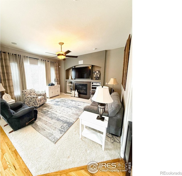 living room featuring ceiling fan and hardwood / wood-style floors