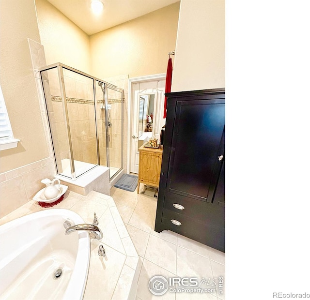 bathroom featuring separate shower and tub, tile patterned flooring, and vanity