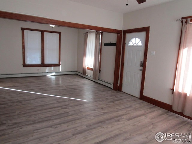 entryway with plenty of natural light, ceiling fan, and light hardwood / wood-style flooring