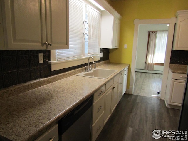 kitchen with tasteful backsplash, sink, dishwasher, white cabinets, and dark hardwood / wood-style floors