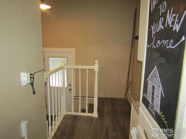 corridor with dark hardwood / wood-style flooring and a baseboard radiator