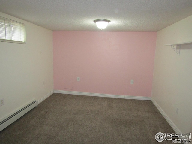 basement with dark carpet, a textured ceiling, and a baseboard radiator