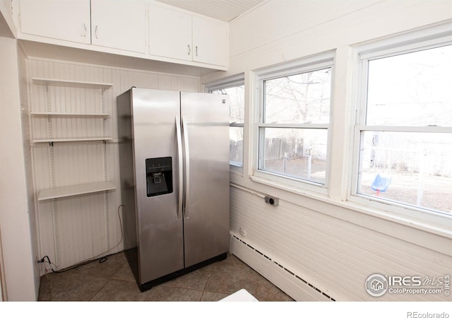 kitchen featuring dark tile patterned floors, white cabinetry, a baseboard radiator, and stainless steel fridge with ice dispenser