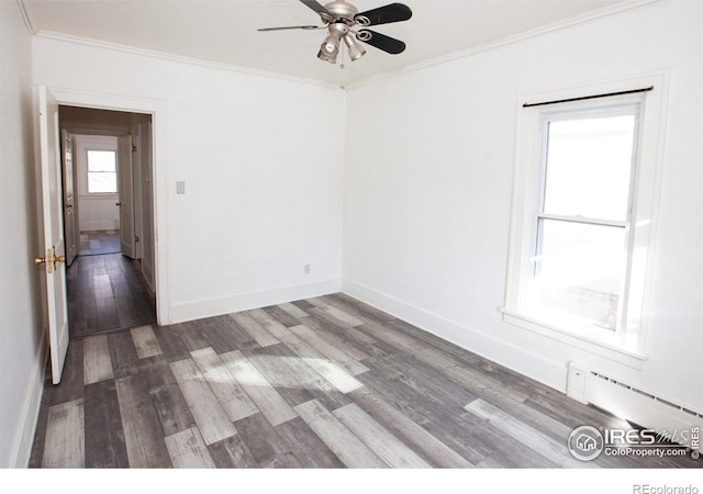 spare room featuring hardwood / wood-style floors, a baseboard radiator, ornamental molding, and ceiling fan