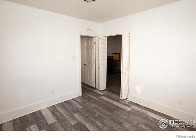 spare room with dark wood-type flooring