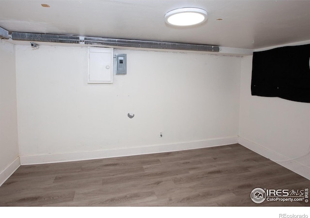 basement with dark hardwood / wood-style floors