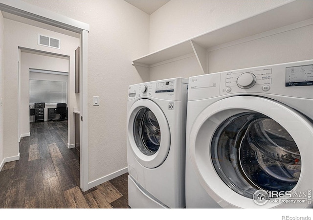 laundry room featuring washer and dryer and dark hardwood / wood-style floors