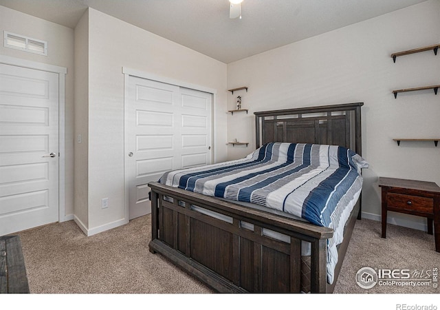 carpeted bedroom featuring a closet and ceiling fan