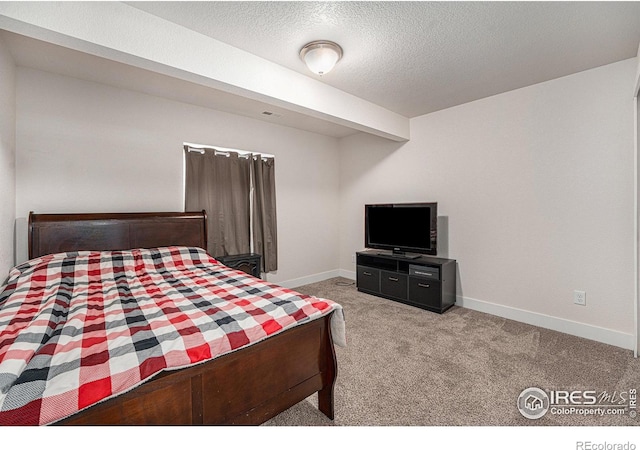 carpeted bedroom featuring a textured ceiling