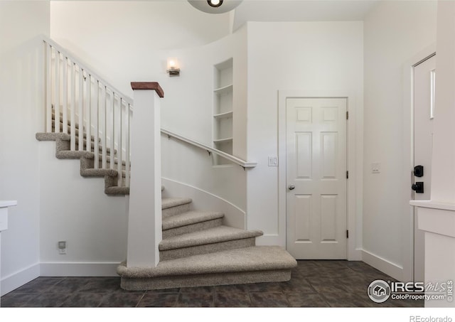 staircase featuring tile patterned floors