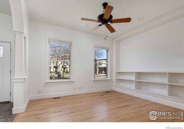 unfurnished room with ceiling fan and light wood-type flooring