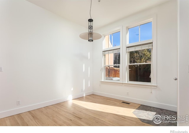 unfurnished room with light hardwood / wood-style flooring