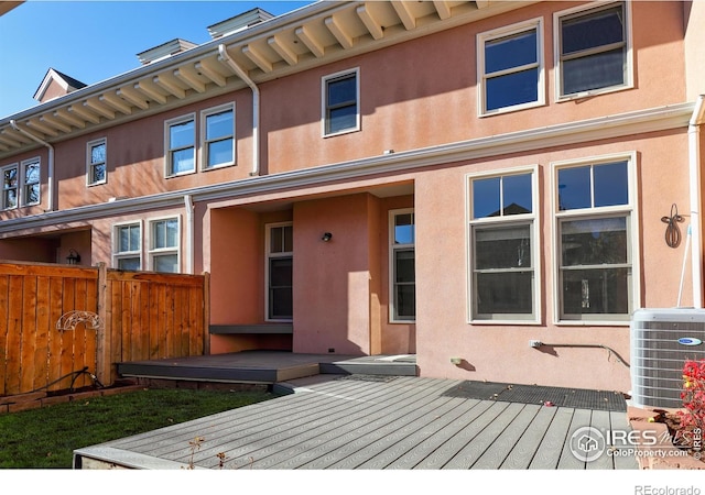 back of house featuring a deck and central air condition unit