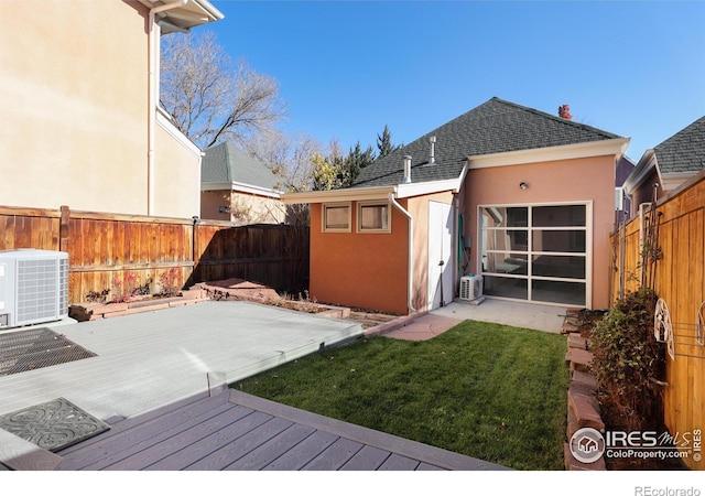 exterior space featuring cooling unit and a lawn