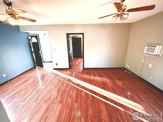 spare room featuring ceiling fan, cooling unit, and dark hardwood / wood-style floors