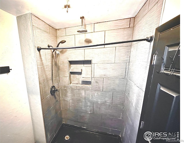 bathroom with a tile shower