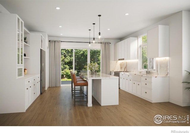 kitchen featuring white cabinets, wood-type flooring, and a kitchen island