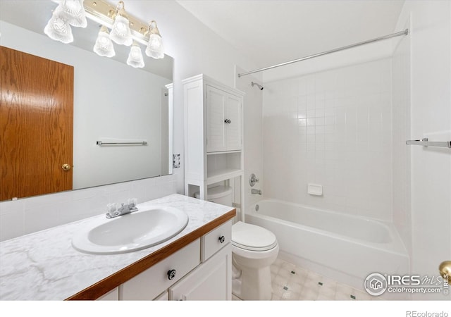 full bathroom with vanity, tiled shower / bath, and toilet