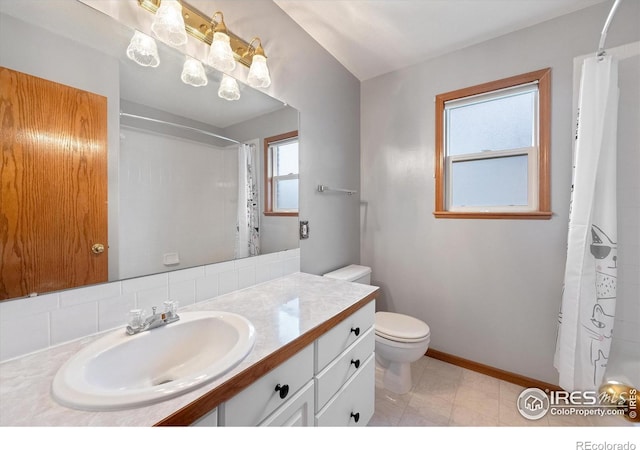 full bathroom featuring tile patterned floors, vanity, toilet, and shower / bath combo