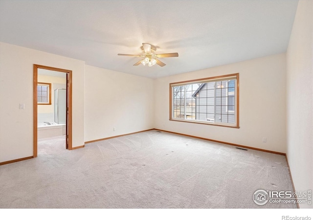 carpeted empty room featuring ceiling fan