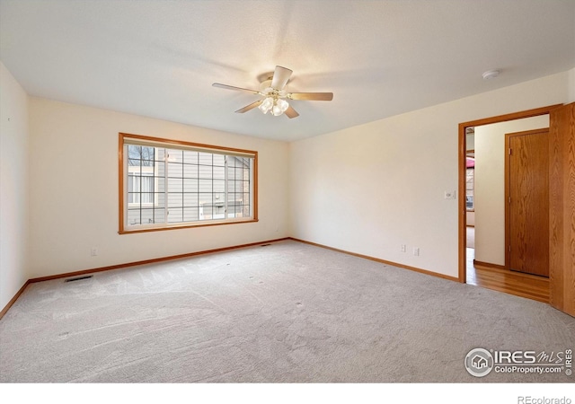 empty room with carpet floors and ceiling fan