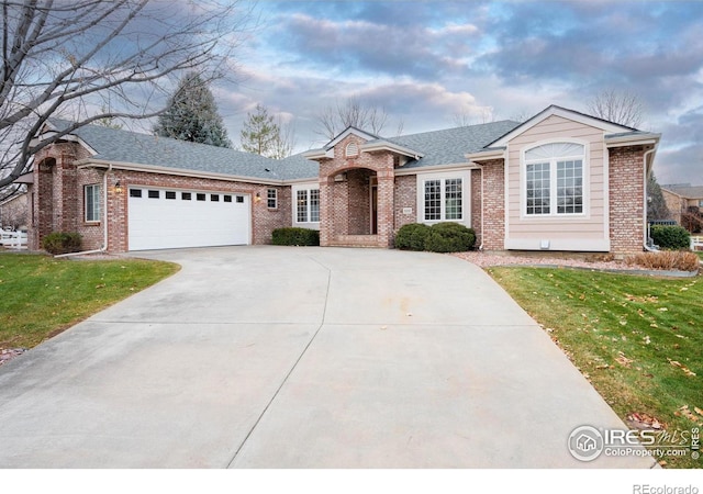 ranch-style house featuring a front lawn and a garage