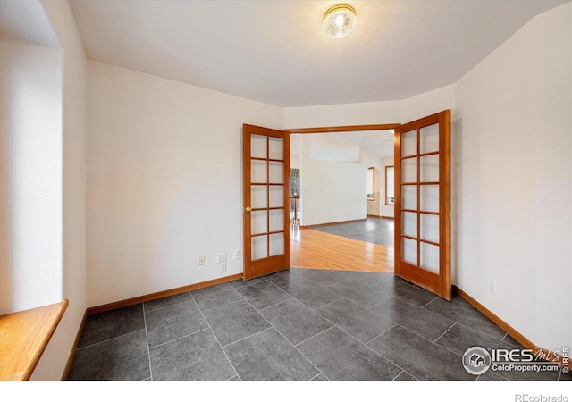 unfurnished room featuring french doors and dark hardwood / wood-style flooring