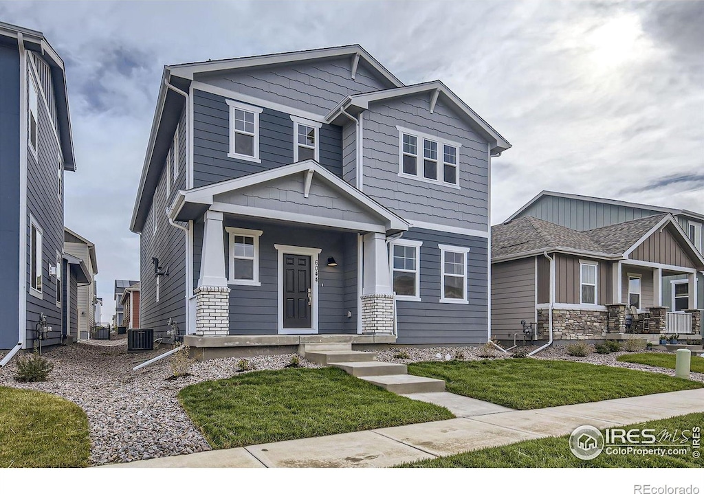 craftsman-style house featuring a front lawn and central AC