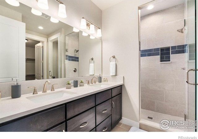 bathroom featuring vanity, tile patterned floors, and a shower with door