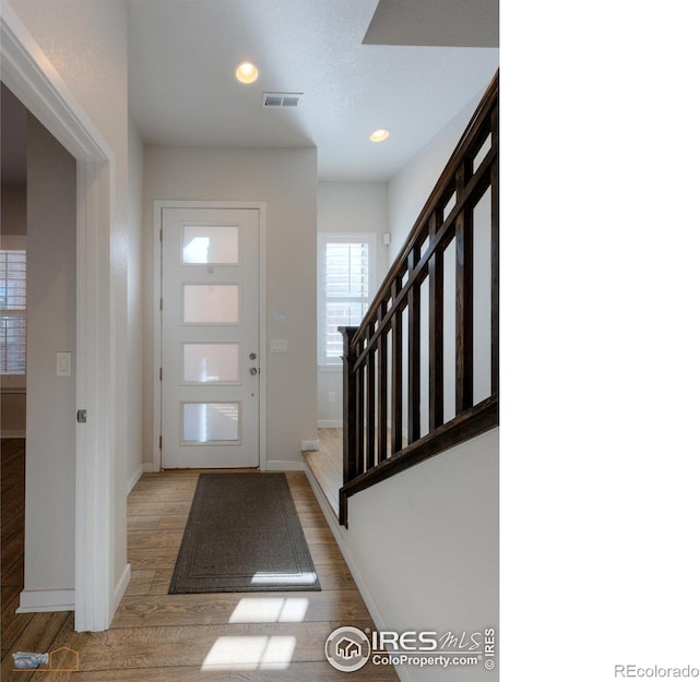 foyer entrance with light hardwood / wood-style flooring